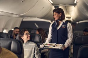 American Airlines flight attendant serving a passenger